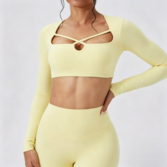 Model wearing a butter yellow long sleeve cutout crop top and fitted leggings set for gym, yoga, and casual wear