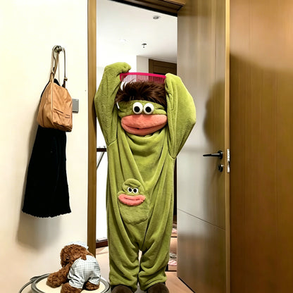 Adult wearing green cartoon monster plush onesie pajamas 
