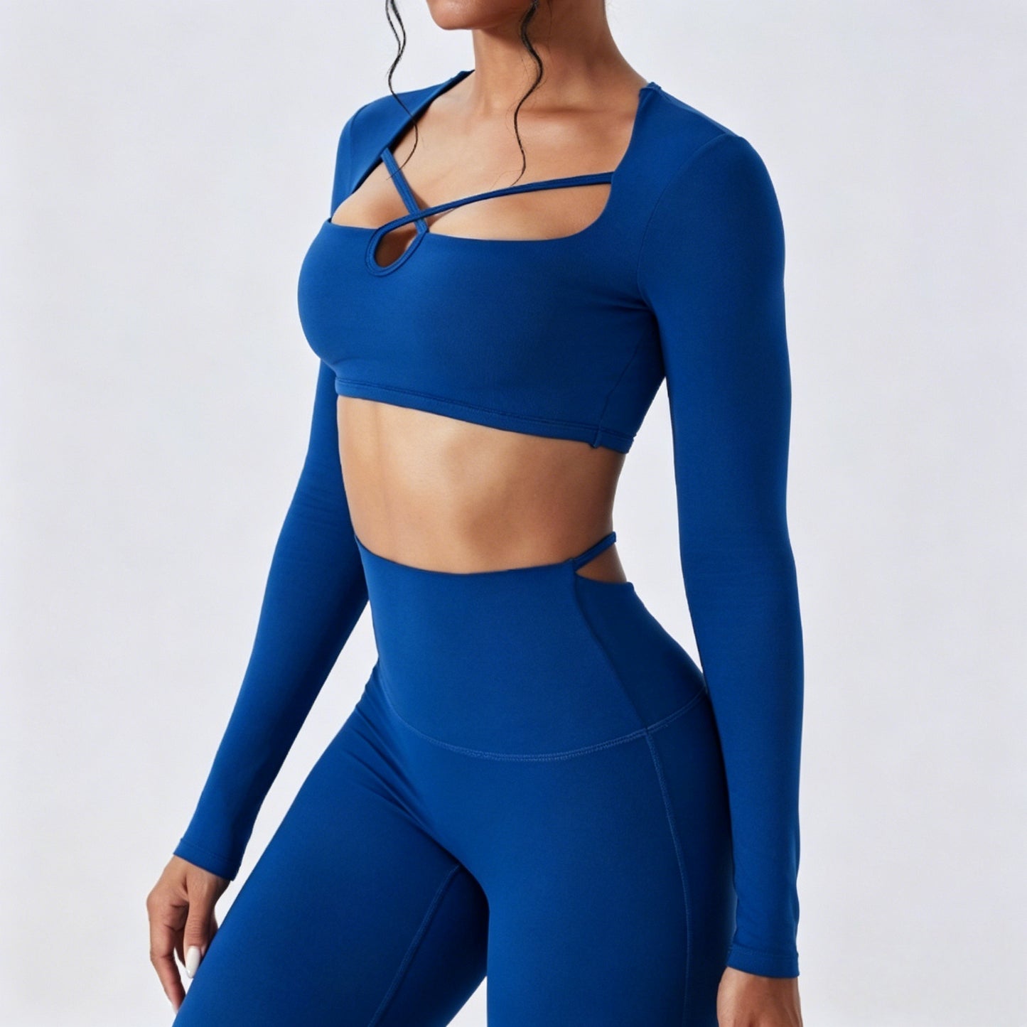Model wearing a royal blue long sleeve cutout crop top and body sculpting leggings set for fitness and everyday styling